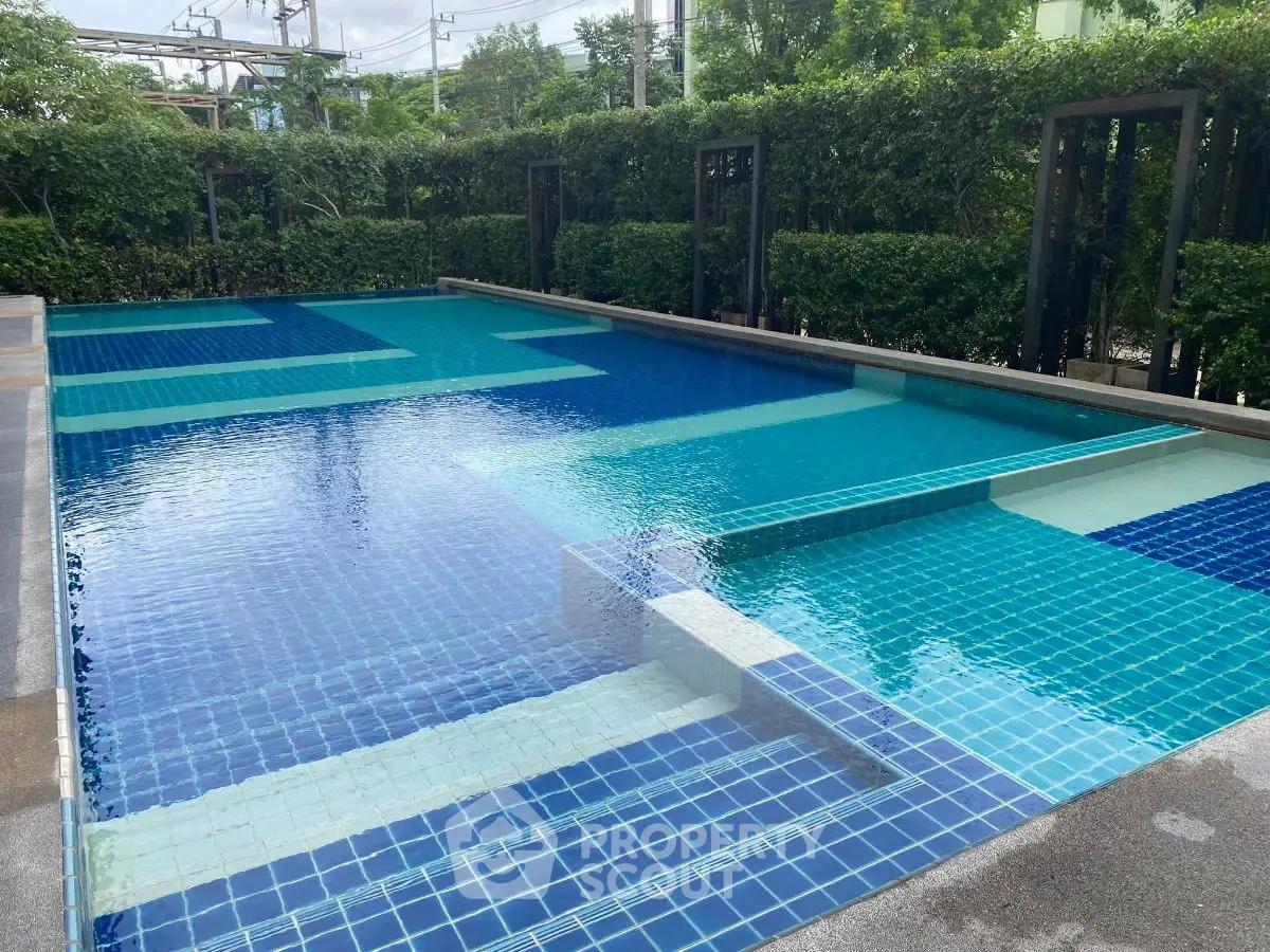 Luxurious residential swimming pool with modern design and lush greenery