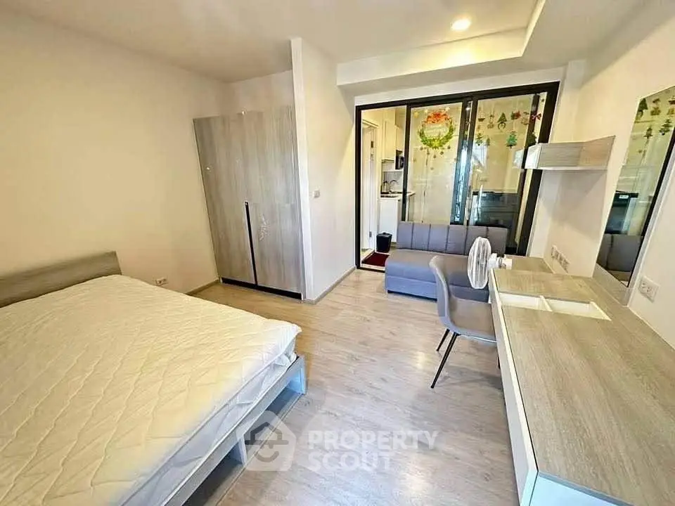 Modern bedroom with stylish furniture and natural light, featuring a cozy workspace and sleek design.