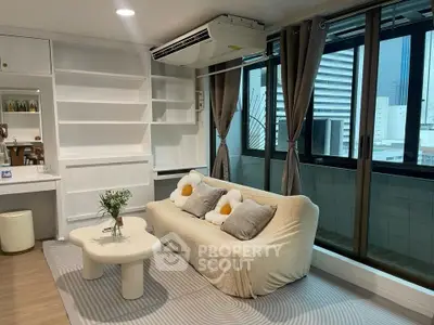 Modern living room with cozy sofa and large windows offering city views