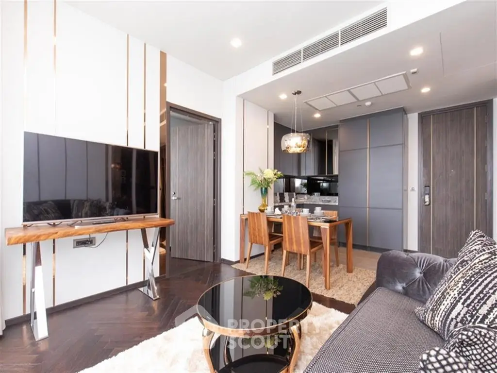 Modern living room with stylish furniture and open kitchen layout in luxury apartment.