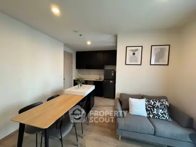 Modern open-plan living room and kitchen with stylish decor and cozy seating area.