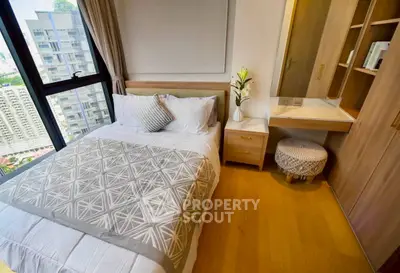 Modern bedroom with city view, featuring cozy bed and stylish decor in a high-rise apartment.