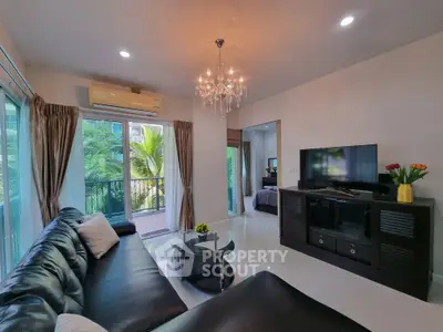Luxurious living room with elegant chandelier and garden view balcony