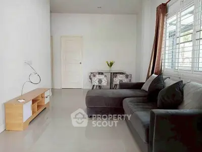 Modern living room with sleek gray sofa and natural light