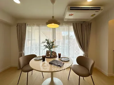 Chic dining area with modern decor and natural light in a stylish apartment.