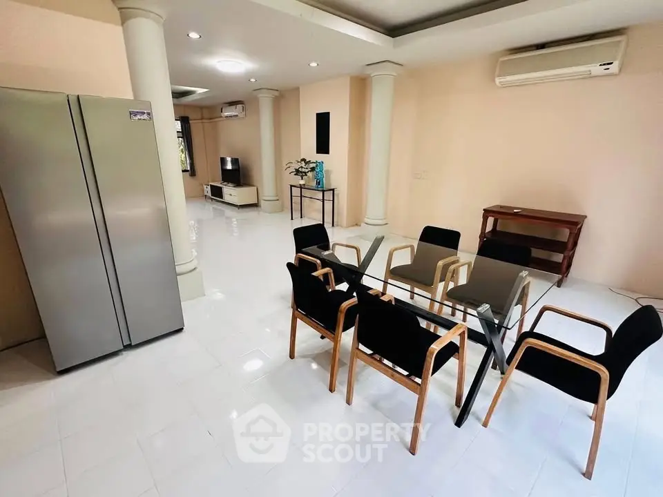 Spacious modern living room with elegant dining area and sleek appliances.