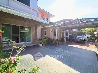 Charming suburban home with spacious driveway and lush greenery, perfect for family living.