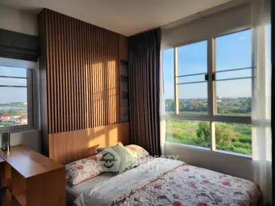 Cozy bedroom with large window offering stunning natural views