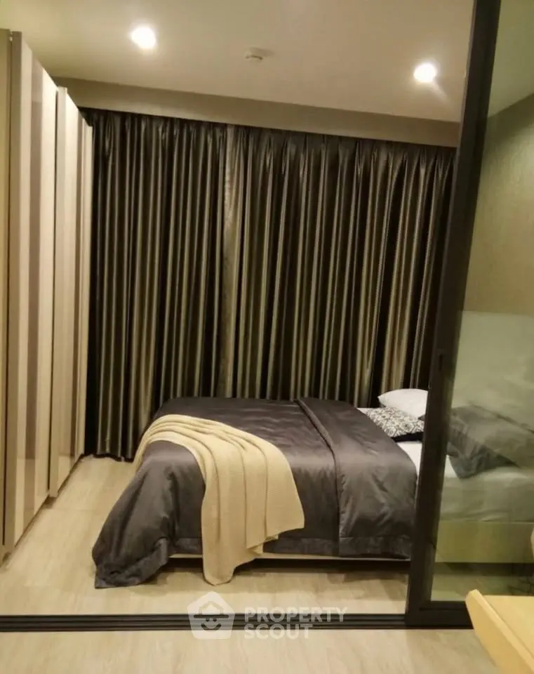 Cozy bedroom with elegant curtains and modern decor in a stylish apartment.