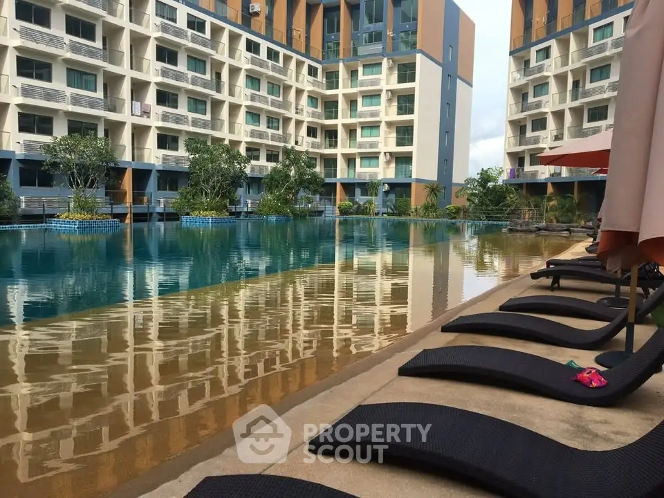Luxurious apartment complex with a stunning poolside view and modern architecture.