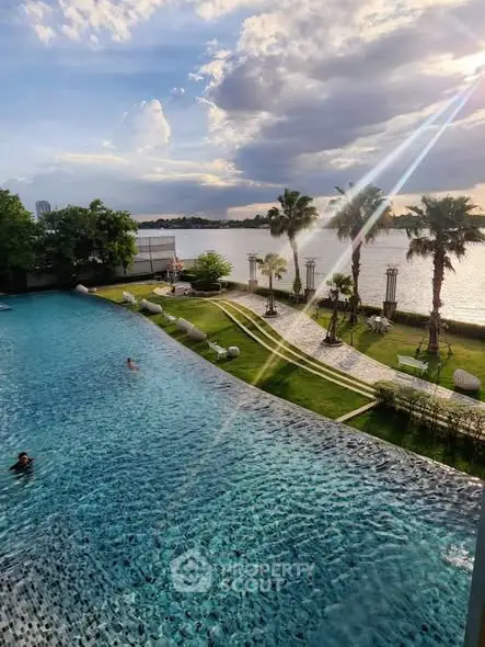 Luxurious poolside view with palm trees and serene waterfront setting