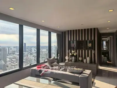 Luxurious high-rise living room with panoramic city views and modern decor.