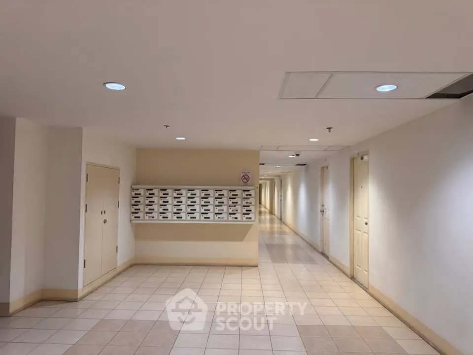 Spacious apartment hallway with mailboxes and tiled flooring