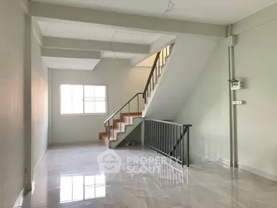 Spacious interior with modern staircase and glossy flooring