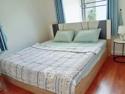 Cozy bedroom with stylish decor and natural light, perfect for relaxation.