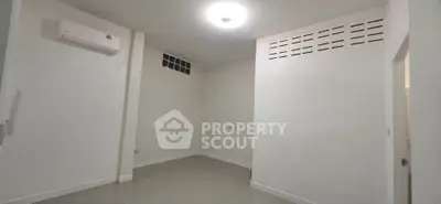 Minimalist empty room with air conditioning and tiled floor, ready for customization.