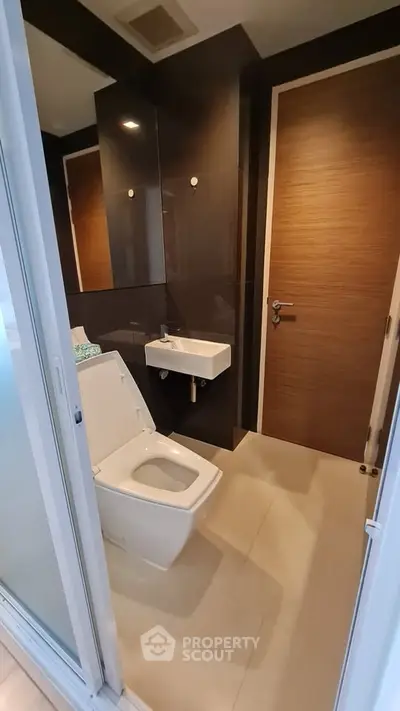 Modern bathroom with sleek design and compact fixtures in a contemporary apartment.