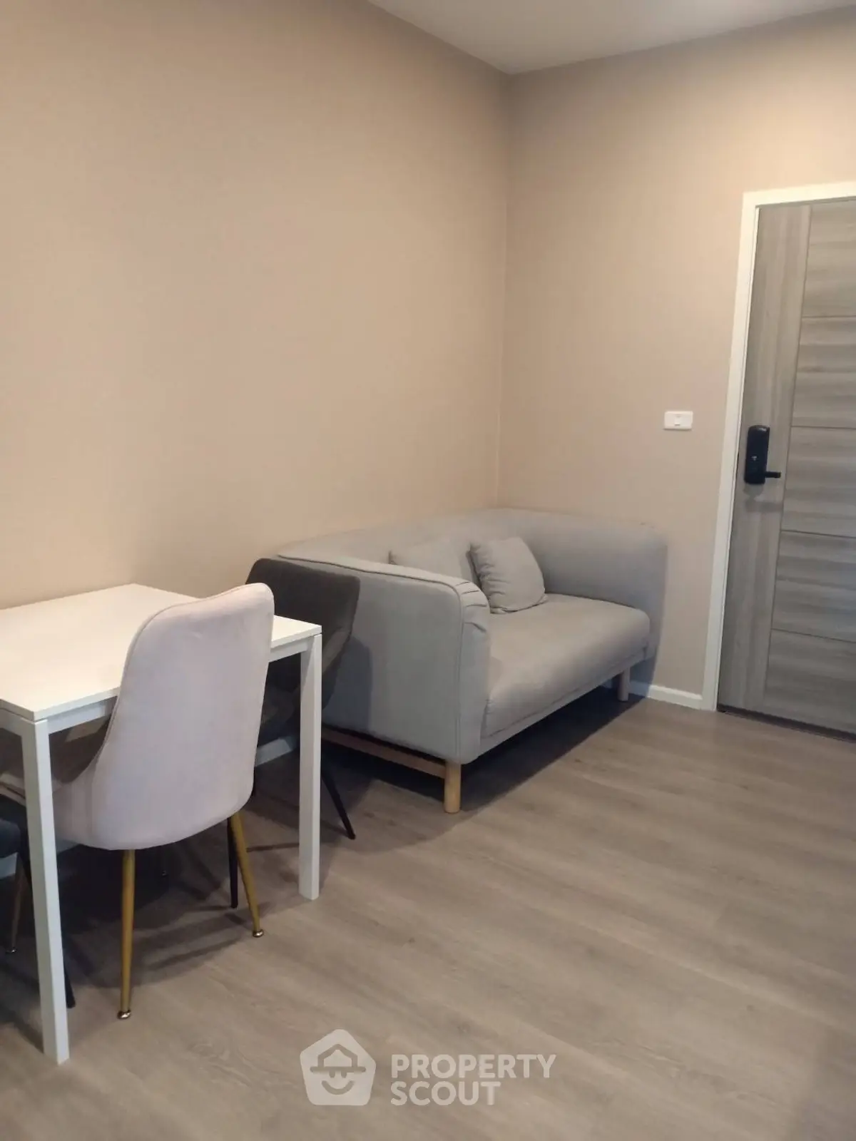 Cozy living room with modern sofa and dining table, perfect for urban living.