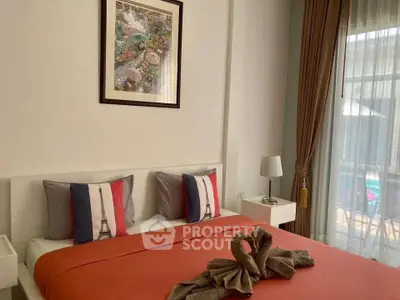 Charming bedroom with elegant decor and pool view, featuring cozy bedding and stylish curtains.
