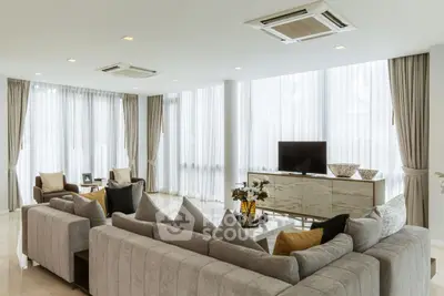 Luxurious living room with elegant decor and ample natural light