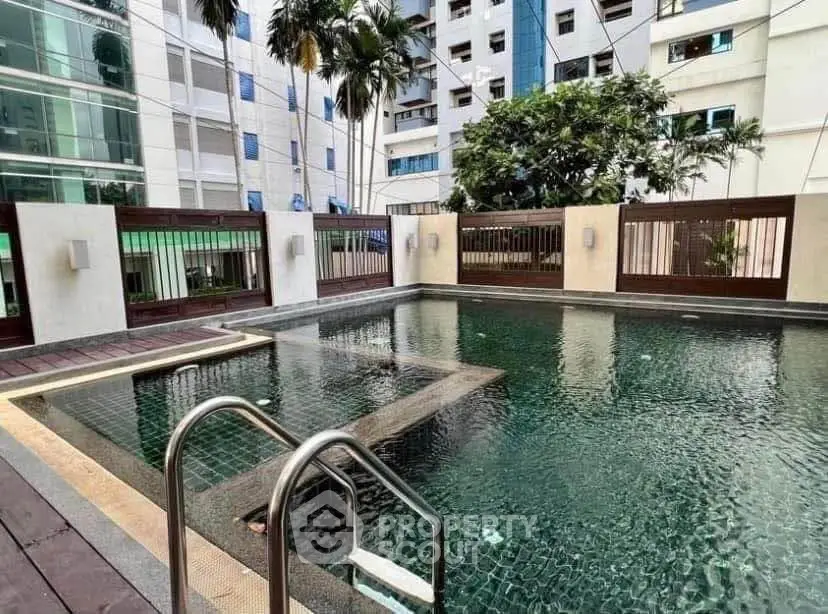Luxurious residential pool area with modern design and lush greenery, perfect for relaxation and leisure.
