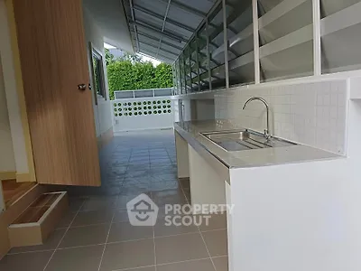 Spacious outdoor kitchen with modern sink and ample counter space, perfect for entertaining.
