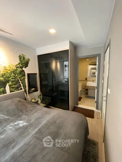 Modern bedroom with ensuite bathroom, featuring sleek design and cozy ambiance.