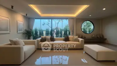 Spacious modern living room with large windows and elegant seating, offering serene views.