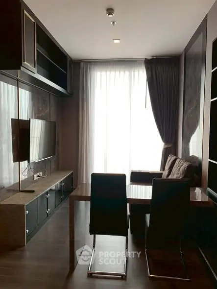 Modern living room with sleek furniture and large window for natural light.