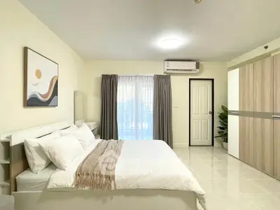 Spacious modern bedroom with elegant decor and ample natural light