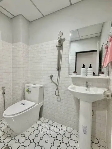 Modern bathroom with sleek white tiles and contemporary fixtures