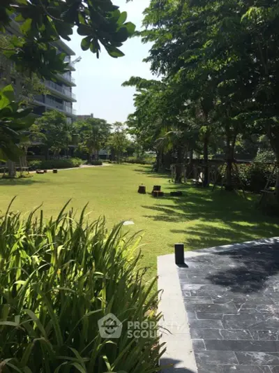 Spacious garden area with lush greenery in a modern residential complex