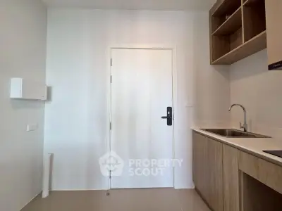 Modern minimalist kitchen with sleek cabinetry and stainless steel sink