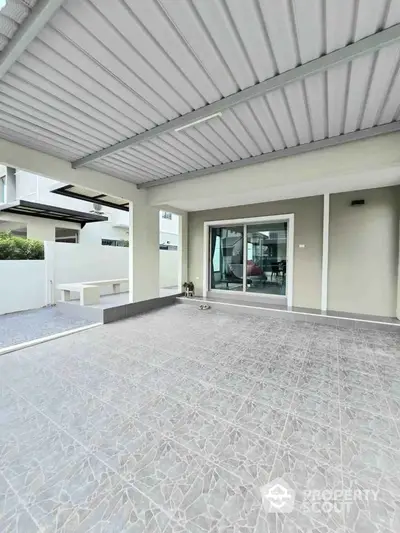 Spacious covered patio with modern design and sliding glass doors