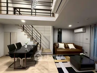 Modern duplex living room with stylish furniture and elegant staircase