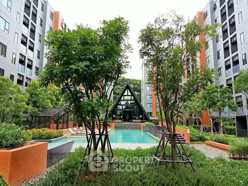 Modern apartment complex with lush garden and inviting swimming pool