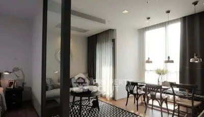 Stylish modern living room with dining area, natural light, and elegant decor.