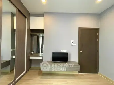 Modern living room with sleek wooden furniture and built-in storage