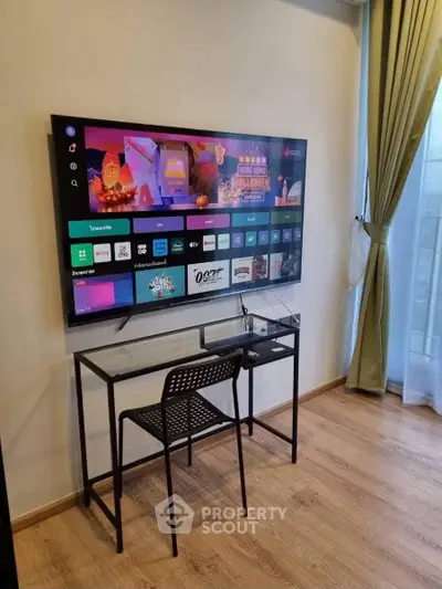 Modern living room with wall-mounted TV and sleek desk setup