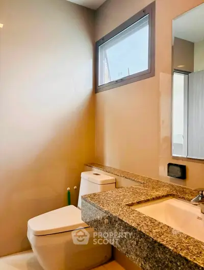 Modern bathroom with granite countertop and sleek design
