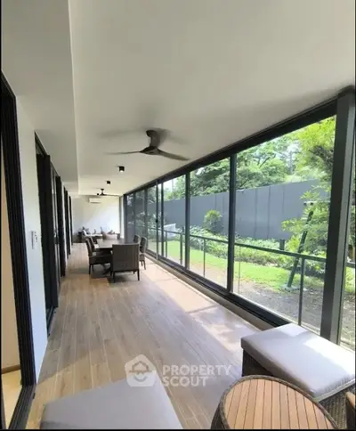 Spacious modern balcony with garden view and elegant seating area