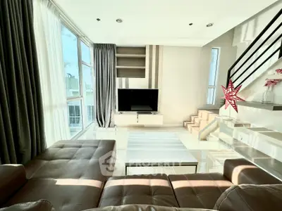 Luxurious modern living room with large windows and stylish staircase