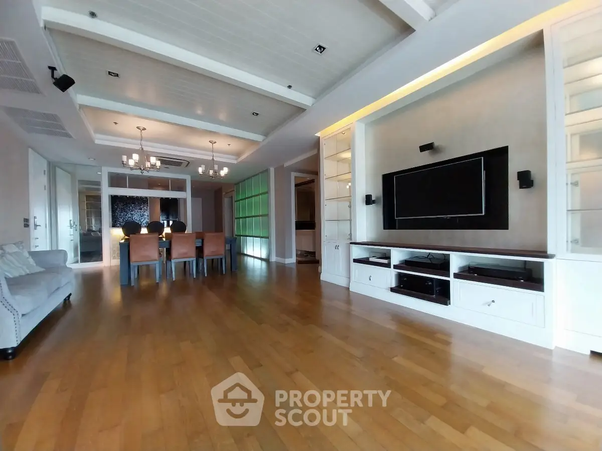 Spacious modern living room with elegant dining area and built-in entertainment center.
