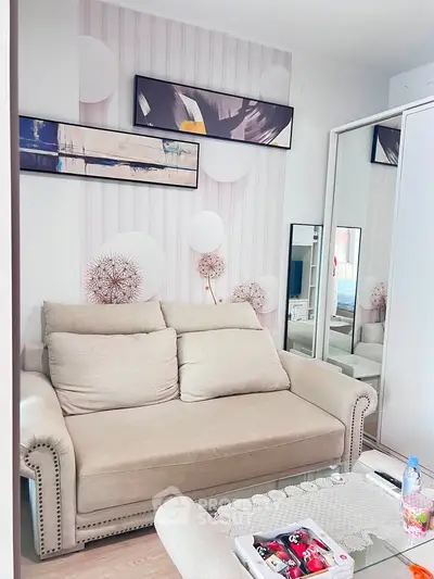 Cozy living room with modern decor and comfortable beige sofa