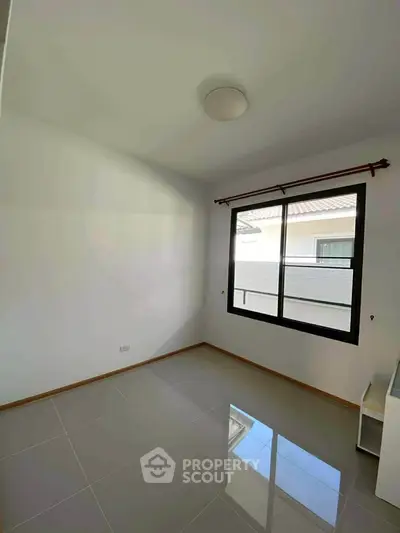 Bright empty room with large window and glossy tiled floor, perfect for customization.