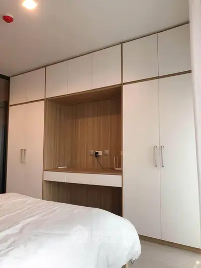 Modern bedroom with built-in wardrobe and sleek design