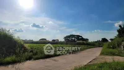 Scenic rural landscape with clear blue sky and lush greenery, perfect for serene living or agricultural development.