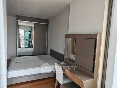 Modern bedroom with sleek furniture and city view from balcony, featuring a comfortable bed and stylish decor.