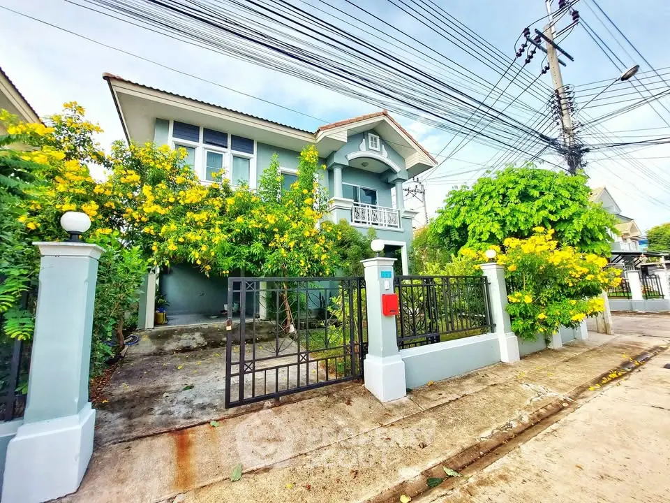 Charming suburban house with lush garden and vibrant yellow flowers