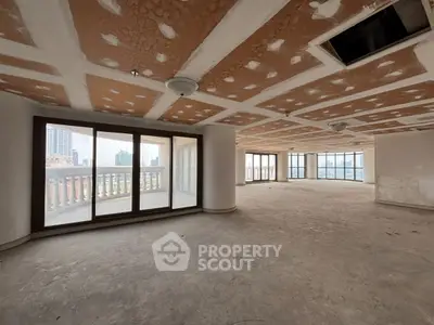 Spacious unfinished apartment with large windows and city view